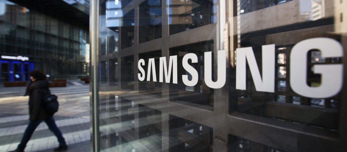 A woman walks past Samsung Electronics Co. signage outside the company's Seocho office building in Seoul, South Korea, on Friday, Feb. 17, 2017. Samsung Group's Jay Y. Lee was formally arrested on allegations of bribery, perjury and embezzlement, an extraordinary step that jeopardizes the executive's ascent to the top role at the world's biggest smartphone maker. Photographer: SeongJoon Cho/Bloomberg via Getty Images